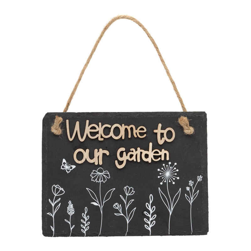 Welcome to Our Garden Slate Sign, dark slate hanging sign with raised lettering reading Welcome to our garden, white wildflower and botanical stem illustrations along the bottom with small butterfly detail, jute rope hanger, on white background