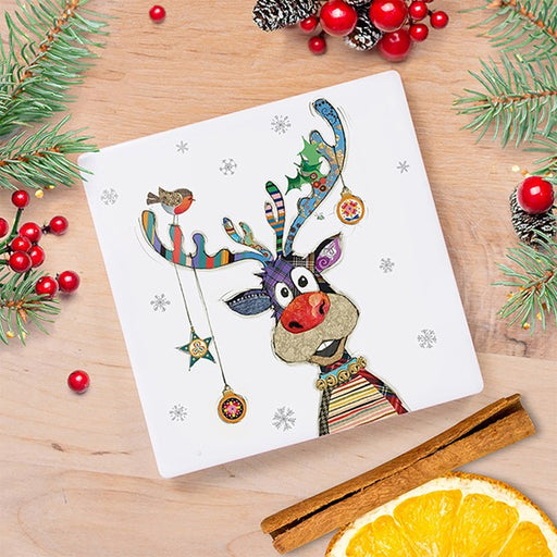  Bug Art Christmas Rudolph coaster featuring a quirky reindeer with colourful patchwork antlers, hanging baubles, a robin and a stripy jumper, styled on a wooden surface with festive foliage