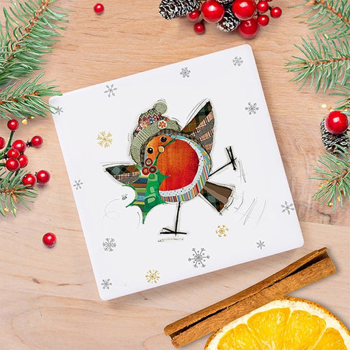 Bug Art Christmas robin coaster featuring a characterful patchwork robin with a bold red breast, little hat and sprig of holly, with gold and silver snowflakes, styled on a wooden surface with festive foliage