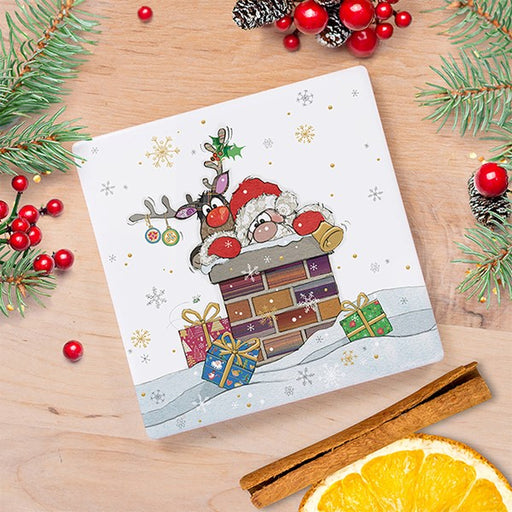 Bug Art Christmas coaster featuring Santa and Rudolph both stuck in a chimney together with gifts in the snow, styled on a wooden surface with festive foliage