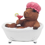 Capybara soaking in a bathtub, wearing a shower cap and holding a cocktail with a citrus garnish