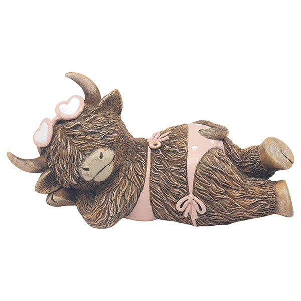 Happy Highland Cow Bikini Time figurine – shaggy highland cow lying down wearing a pink bikini and heart-shaped sunglasses, with curved horns