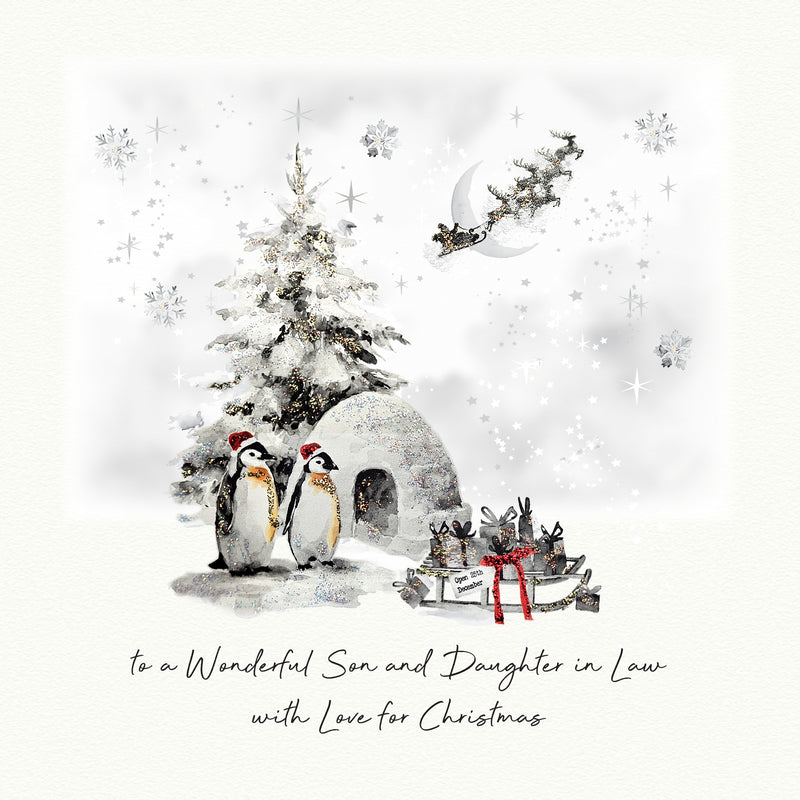 An illustrated Christmas card showing two penguins in Santa hats beside a snow-dusted Christmas tree and igloo, with Santa's sleigh flying past a crescent moon and a sledge of wrapped gifts nearby, with the sentiment "to a Wonderful Son and Daughter in Law with Love for Christmas"