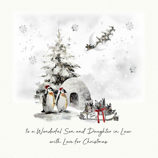 An illustrated Christmas card showing two penguins in Santa hats beside a snow-dusted Christmas tree and igloo, with Santa's sleigh flying past a crescent moon and a sledge of wrapped gifts nearby, with the sentiment "to a Wonderful Son and Daughter in Law with Love for Christmas"