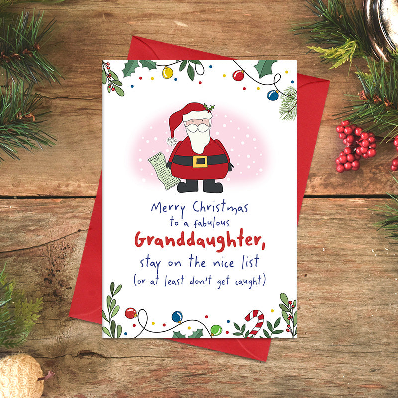 Granddaughter Christmas card featuring illustrated Santa holding a list, with the message ‘Stay on the nice list, or at least don't get caught’, framed by festive foliage and baubles
