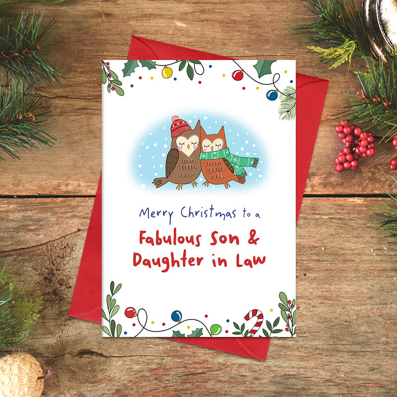 Fabulous Son and Daughter-in-Law Christmas card featuring two illustrated owls nestled together, one wearing a bobble hat and the other wrapped in a scarf, framed by festive foliage and baubles