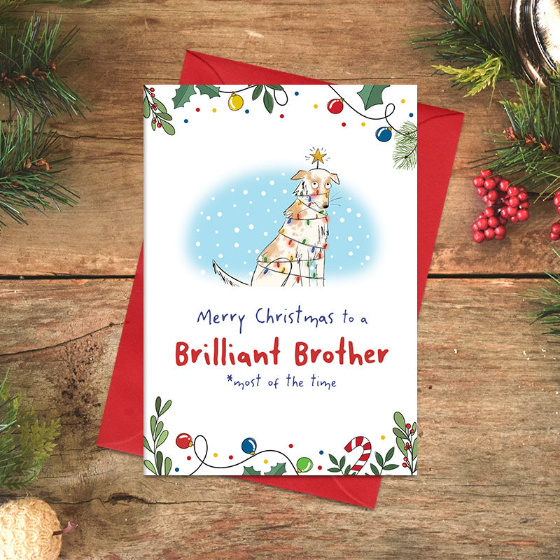 Brilliant Brother Christmas card featuring an illustrated dog wrapped in fairy lights with a star above its head, and the cheeky message ‘most of the time’ beneath the greeting