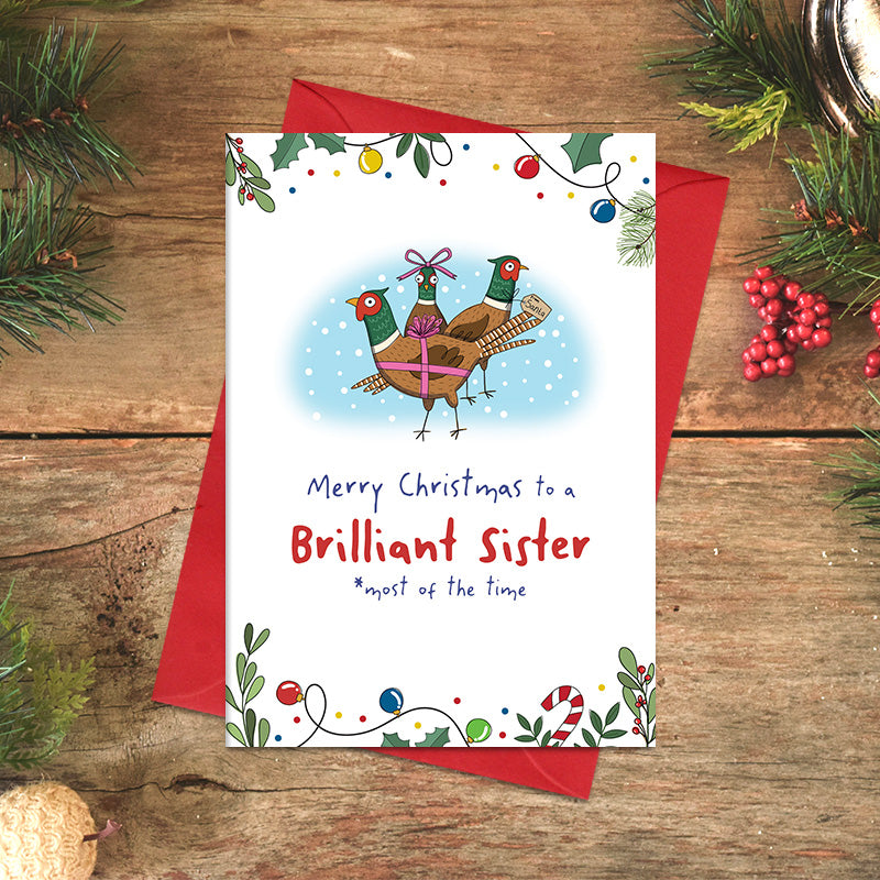 Brilliant Sister Christmas card featuring three illustrated festive birds decorated with ribbon and bows, with the cheeky message ‘most of the time’ beneath the greeting.