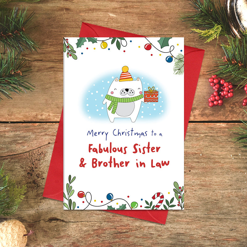 Fabulous Sister and Brother-in-Law Christmas card featuring a cheerful illustrated character in a scarf and bobble hat holding a wrapped present, framed by festive foliage and baubles