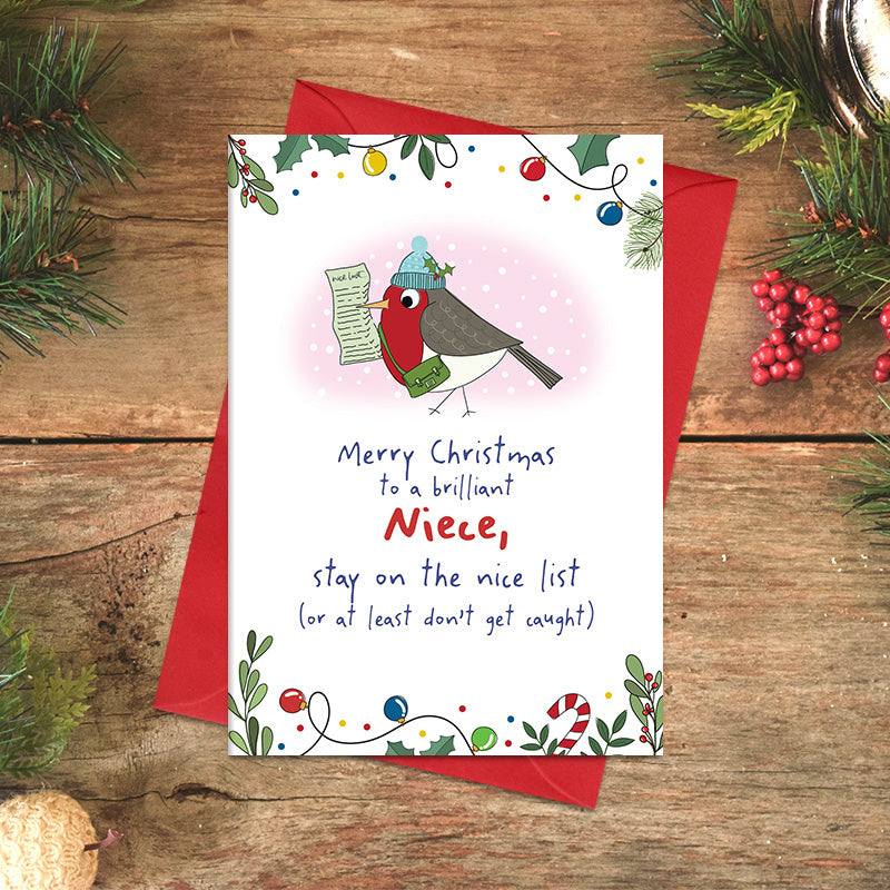 Niece Christmas card featuring an illustrated robin in a bobble hat carrying a nice list, with the message ‘Stay on the nice list, or at least don't get caught