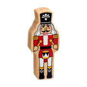 Wooden nutcracker toy with tall hat, curled moustache, beard, traditional uniform and painted drum and drumsticks