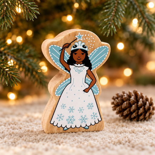 Wooden snow fairy toy beneath Christmas tree branches beside a pinecone and warm fairy lights