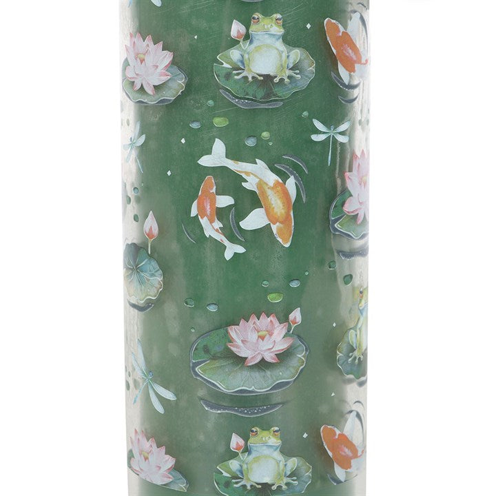Close-up of Pond Print candle wrap featuring illustrated frogs, lily pads, dragonflies and koi fish in green and teal tones