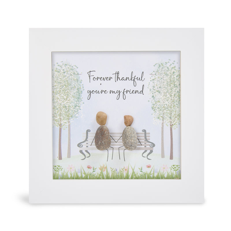 "Forever thankful you're my friend" glitter mini plaque, white frame with two pebble figures sitting on an ornate bench holding hands, sparkling trees and wildflower meadow border