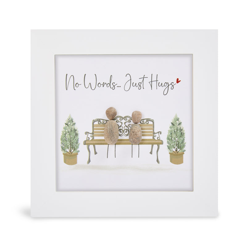 "No Words… Just Hugs" glitter mini plaque, white frame with two pebble figures sitting on an ornate bench flanked by sparkling topiary trees and a small red heart