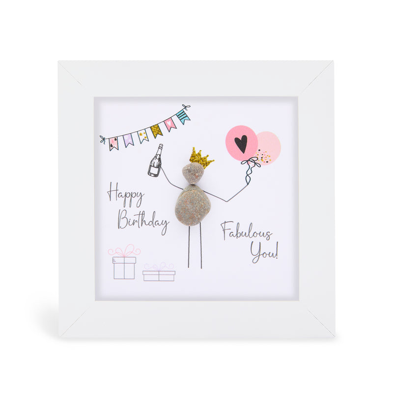 "Happy Birthday Fabulous You!" mini plaque, white frame with a pebble figure wearing a gold crown, holding a champagne bottle in one hand and two balloons in the other, with colourful bunting and gift boxes