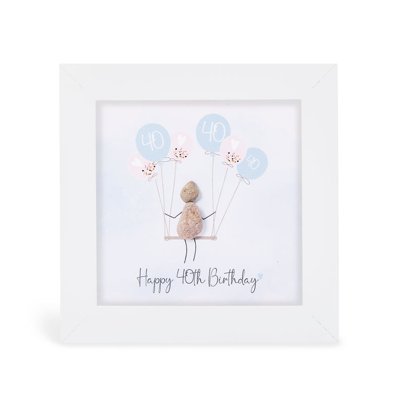 "Happy 40th Birthday" mini plaque, white frame with a pebble figure sitting on a swing holding a bunch of blue and pink balloons