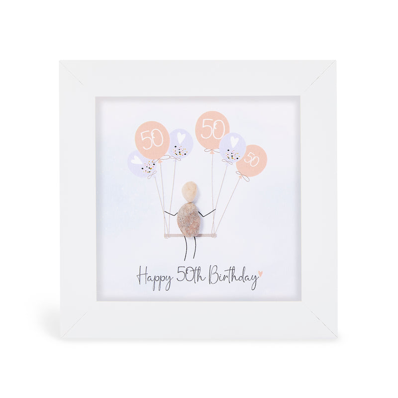 "Happy 50th Birthday" mini plaque, white frame with a pebble figure sitting on a swing holding a bunch of peach and lilac balloons