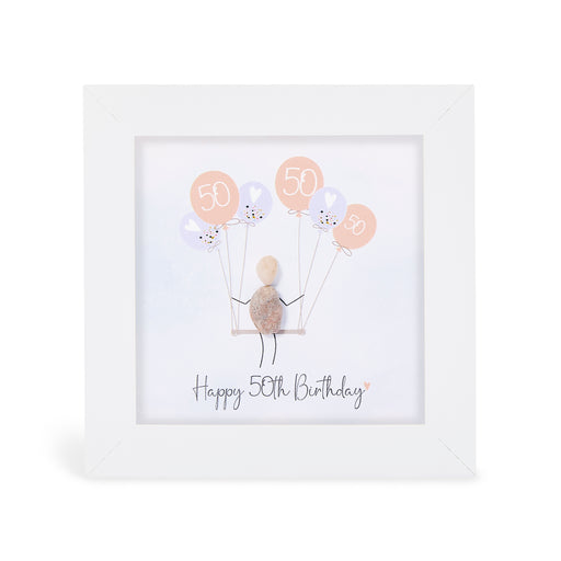 "Happy 50th Birthday" mini plaque, white frame with a pebble figure sitting on a swing holding a bunch of peach and lilac balloons