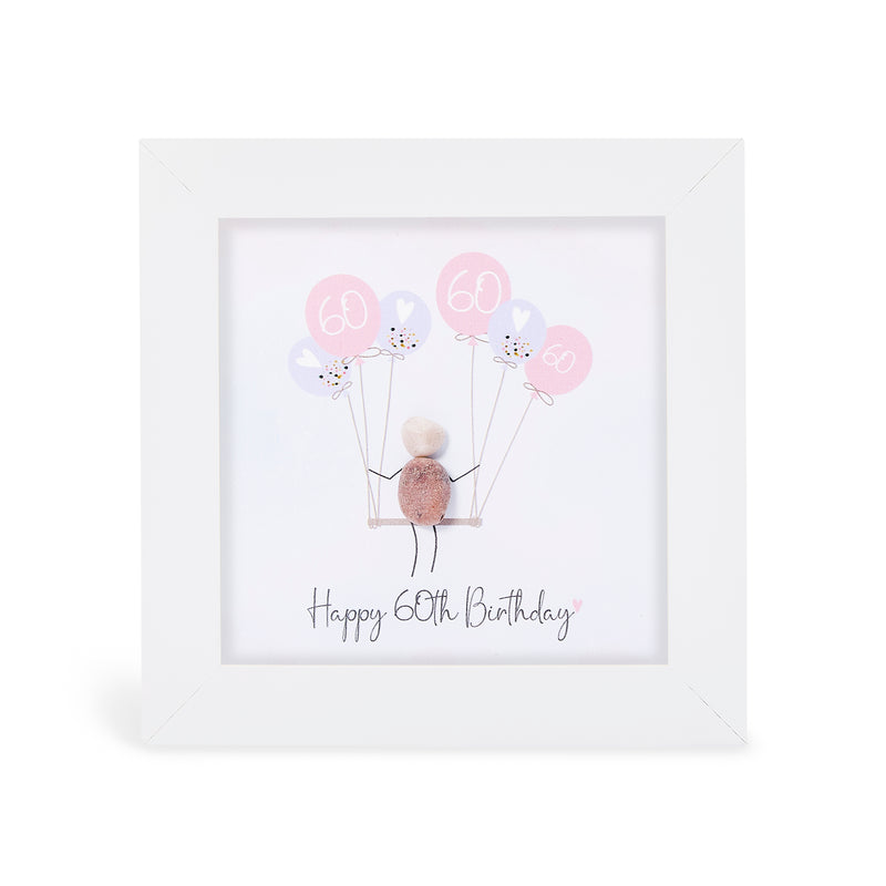 "Happy 60th Birthday" mini plaque, white frame with a pebble figure sitting on a swing holding a bunch of pink and lilac balloons