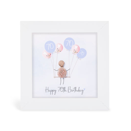 "Happy 70th Birthday" mini plaque, white frame with a pebble figure sitting on a swing holding a bunch of pink and lilac balloons printed with the number 70