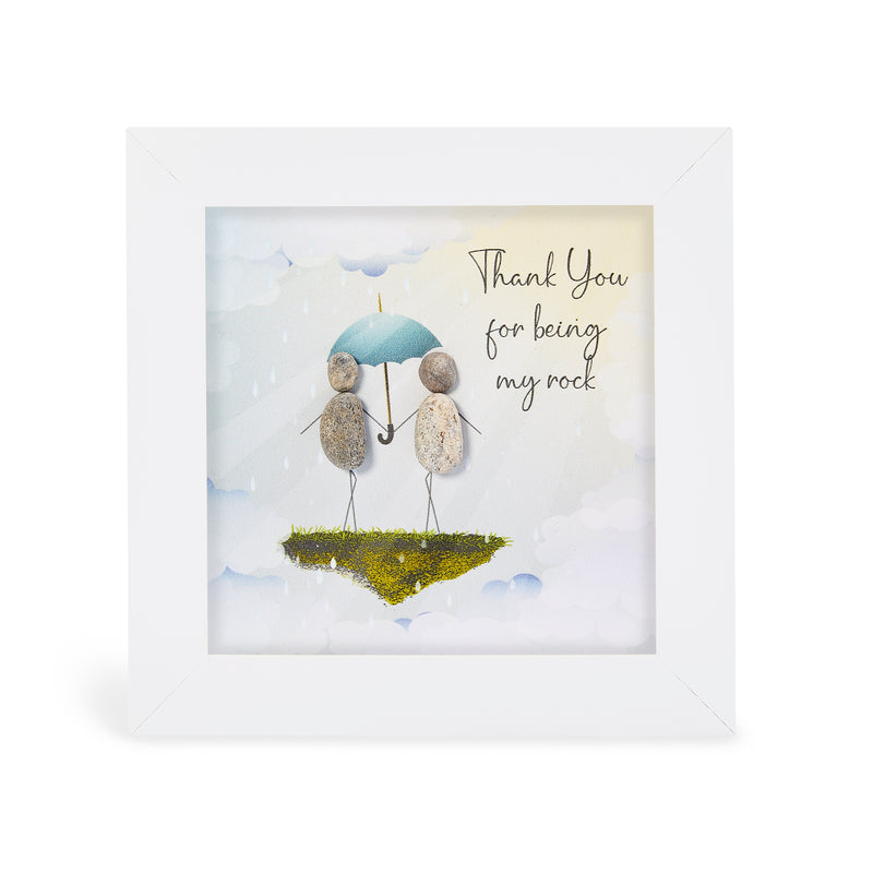"Thank You for being my rock" mini plaque, white frame with two pebble figures sharing a blue umbrella on a floating mossy island against a cloudy sky