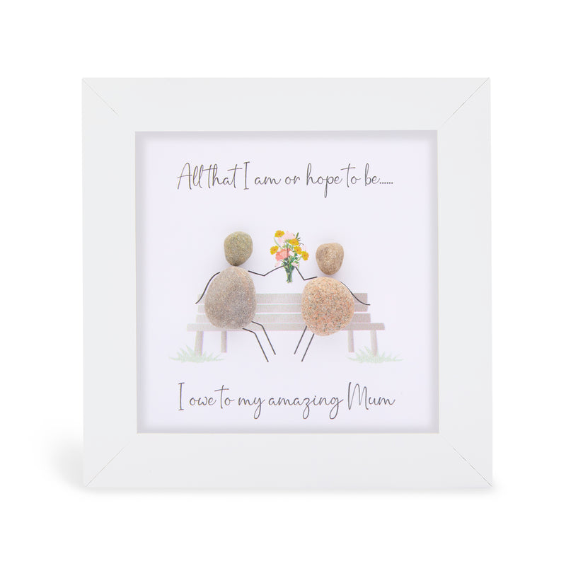 All that I am or hope to be….. I owe to my amazing Mum" mini plaque, white frame with two pebble figures sitting on a bench with a bouquet of flowers between them