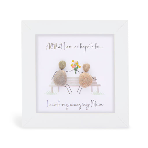 All that I am or hope to be….. I owe to my amazing Mum" mini plaque, white frame with two pebble figures sitting on a bench with a bouquet of flowers between them