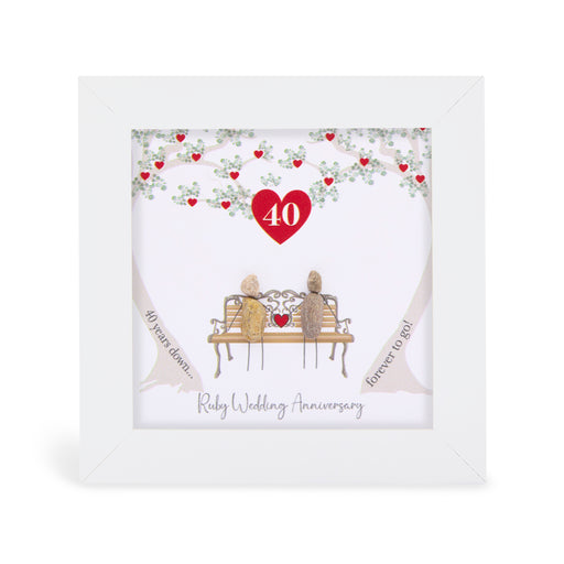 Pebble art framed plaque with two natural pebble figures on an ornate bench beneath a tree with ruby red hearts, a red heart with the number 40 above them, and the sentiment "40 years down... forever to go! Ruby Wedding Anniversary", white frame