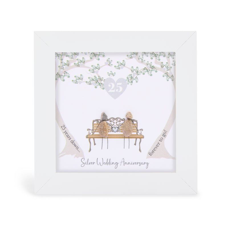 Pebble art framed plaque with two natural pebble figures on an ornate bench beneath a silver tree, a silver heart with the number 25 above them, and the sentiment "25 years down... forever to go! Silver Wedding Anniversary", white frame