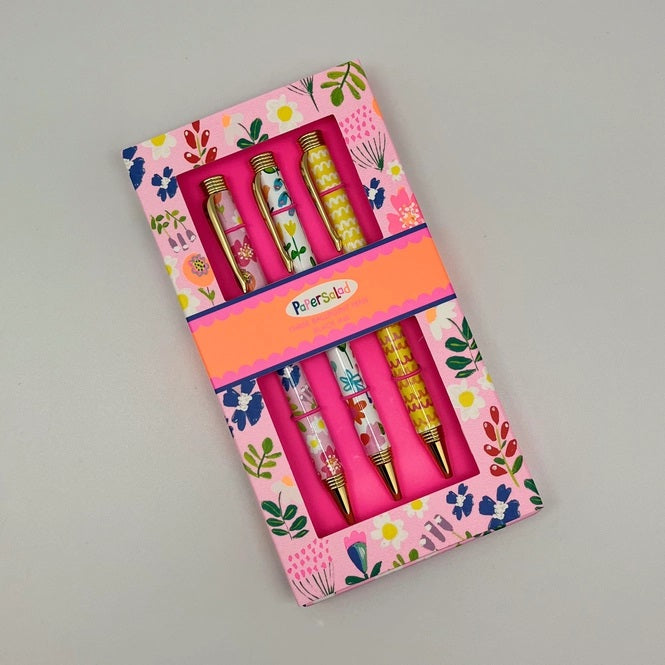 Paper Salad Floral Pen Gift Set flat lay showing closed floral gift box with three pens visible through window with gold-tone fittings and Paper Salad label