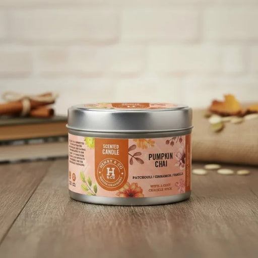 Henry & Co Pumpkin Chai scented candle 20cl in a silver tin with autumn spice label on a wooden surface