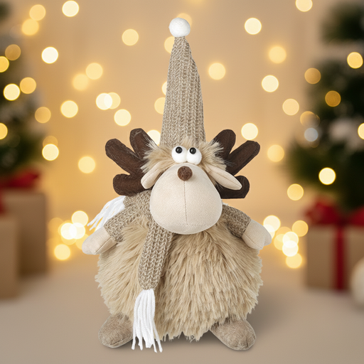 A fluffy fawn sitting moose decoration with dark brown fabric antlers, a tall knitted pompom hat, googly eyes, a brown nose and a knitted scarf with tassels, displayed against a warm golden Christmas background with soft bokeh fairy lights