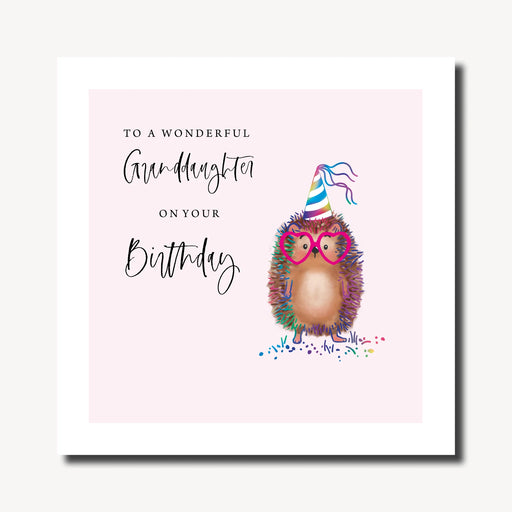 Birthday card for granddaughter with illustrated hedgehog in rainbow party hat and heart-shaped glasses on a soft pink background, with rainbow foil finish, 210 x 210mm