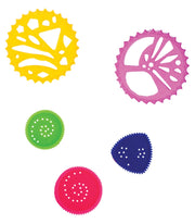 Selection of spiro wheels in yellow, pink, green, navy and red with cutout designs, white background