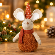 Sitting mouse decoration with heart hat displayed on a wooden surface with warm golden bokeh fairy lights in the background