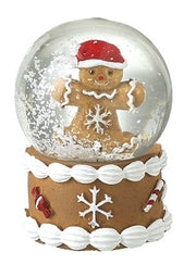 Gingerbread Christmas snow globe featuring a character in a Santa hat above a snowflake-decorated base.