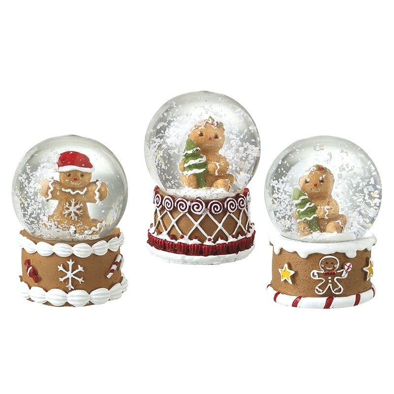 Three gingerbread Christmas snow globe designs with decorative icing-style bases.
