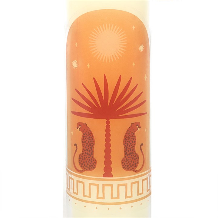 Close-up of Leopard Palm candle wrap featuring illustrated leopards flanking a palm tree with a sunburst and stars on a warm orange background