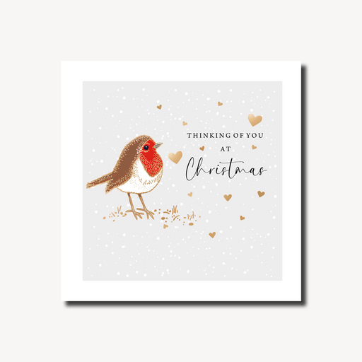 Thinking of you Christmas card featuring a robin standing in the snow surrounded by scattered gold foil hearts on a soft grey background, foil finish, 155 x 155mm