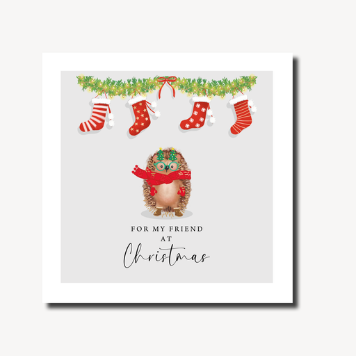 Christmas card for a friend featuring a hedgehog in a red scarf and Christmas tree glasses standing beneath a lit garland with four festive stockings on a soft grey background, gold foil finish, 155 x 155mm