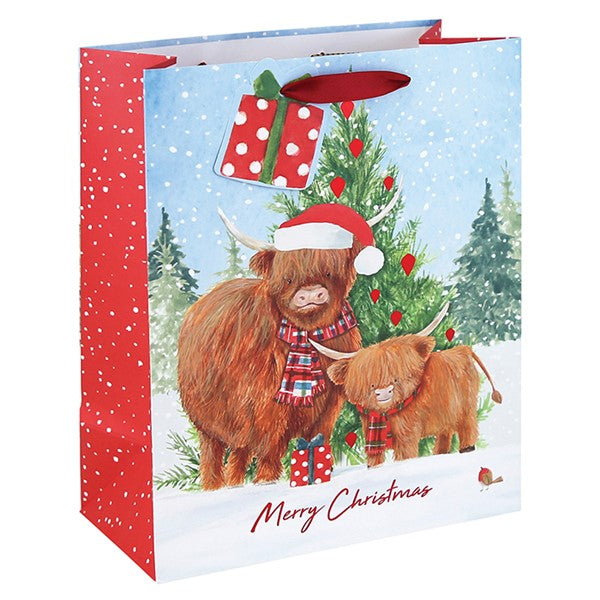 Large Christmas gift bag with highland cow and calf in tartan scarves and Santa hat, snow-dusted Christmas tree, Merry Christmas text, red snowflake side panel and gift tag