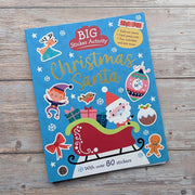 Big Sticker Activity Book Christmas Santa, front cover lifestyle shot on wooden surface with festive props