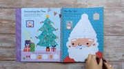 Big Sticker Activity Book Christmas Santa, open spread showing Decorating the Tree counting activity on left and Ho Ho Ho dot-to-dot Santa colouring page on right, wooden surface