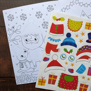 Dress Me Up Santa Colouring and Activity Book, lifestyle shot showing open book with colouring page and sticker sheet on wooden surface