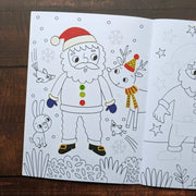 Dress Me Up Santa Colouring and Activity Book, lifestyle shot showing completed Santa colouring page with stickers applied, reindeer and woodland animals