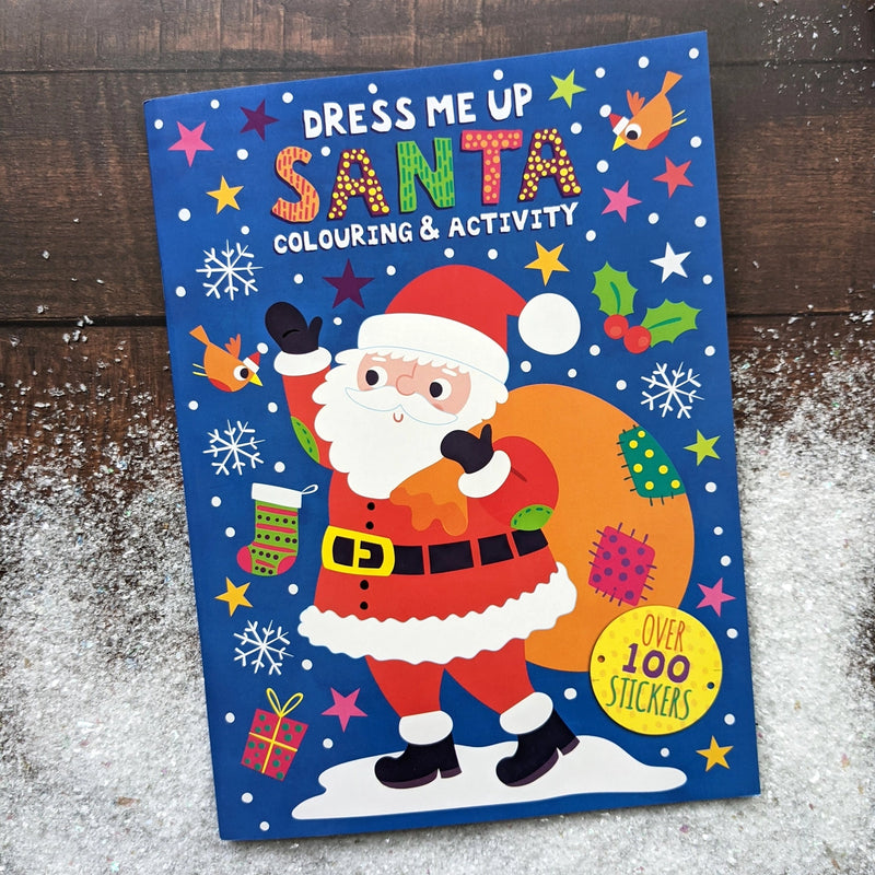 Dress Me Up Santa Colouring and Activity Book, lifestyle shot of front cover on snowy wooden surface