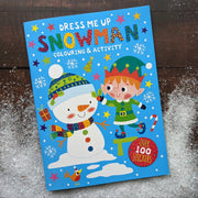 Dress Me Up Snowman Colouring and Activity Book, lifestyle shot of front cover on snowy wooden surface