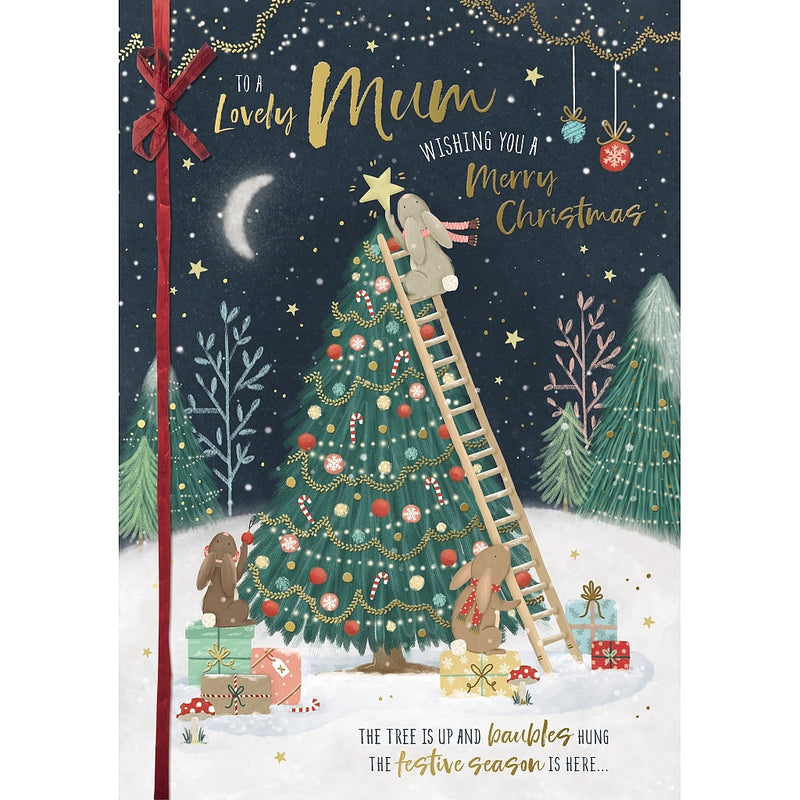 Lovely Mum Christmas card featuring illustrated rabbits decorating a Christmas tree, with one on a ladder placing the star, surrounded by presents and snowy woodland scenery