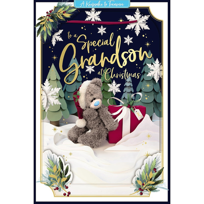 Special Grandson 3D-effect Christmas card featuring Tatty Teddy sitting in a Santa hat beside a wrapped present tied with a bow, surrounded by Christmas trees, snowflakes and festive foliage.